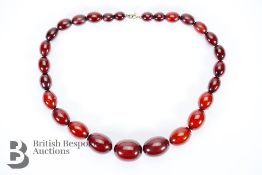 Red Amber graduated bead necklace, on a wire clasp. The beads measure from 7mm to 27mm, 46 cms in