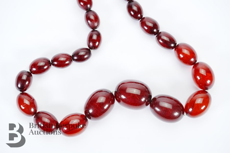 Red Amber graduated bead necklace, on a wire clasp. The beads measure from 7mm to 27mm, 46 cms in - Image 2 of 4