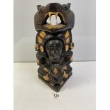 A CARVED WOODEN CENTRAL AMERICAN TOTEM STYLE FIGURE AND SERPENT. 42 CMS.