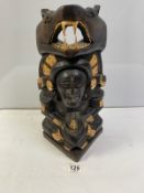 A CARVED WOODEN CENTRAL AMERICAN TOTEM STYLE FIGURE AND SERPENT. 42 CMS.