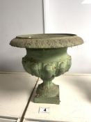 A SMALL CAST IRON GREEN PAINTED FLUTED URN ON SQUARE BASE. 26X26.