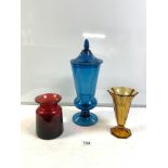 A TALL BLUE GLASS JAR AND COVER, 42 CMS, AND AMBER GLASS VASE AND RED GLASS VASE.
