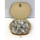 A QUANTITY OF COSTUME JEWELLERY, IN A SHAPED TAPESTRY BOX.