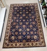 A KASHAN BLUE, RED AND CREAM PATTERNED CARPET, 250X360 CMS.