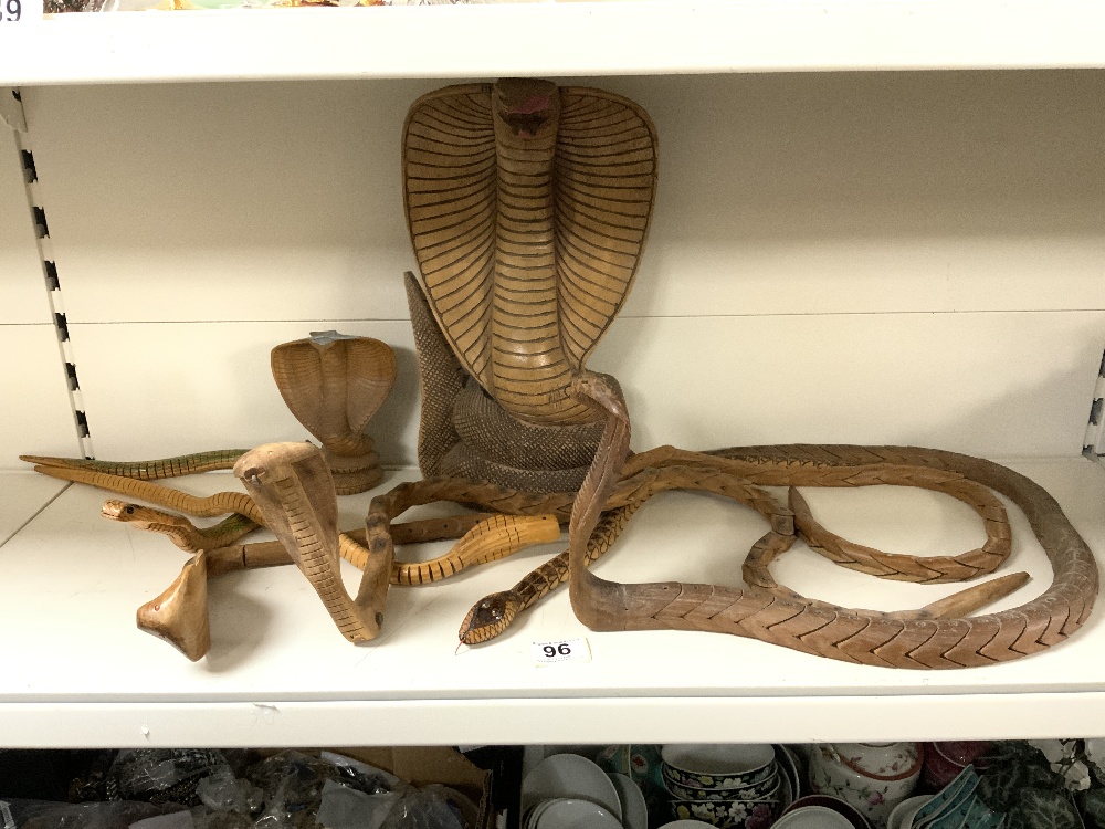 A CARVED WOODEN FIGURE OF A COBRA, AND THREE CARVED ARTICULATED WOODEN COBRAS.