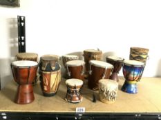 A COLLECTION OF SMALL AFRICAN TRIBAL DRUMS.