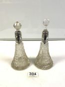 A PAIR OF HALLMARKED SIVER MOUNTED CUT GLASS SCENT BOTTLES, [ 1 WRONG STOPPER. ] 16 CMS.