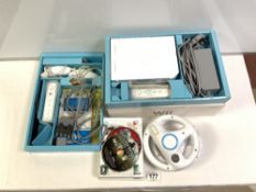 A NINTENDO Wii, TWO STEERING WHEEL CONTROLS AND FIVE GAMES.