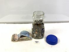 A JAR OF FORIEGN COINS AND NOTES.