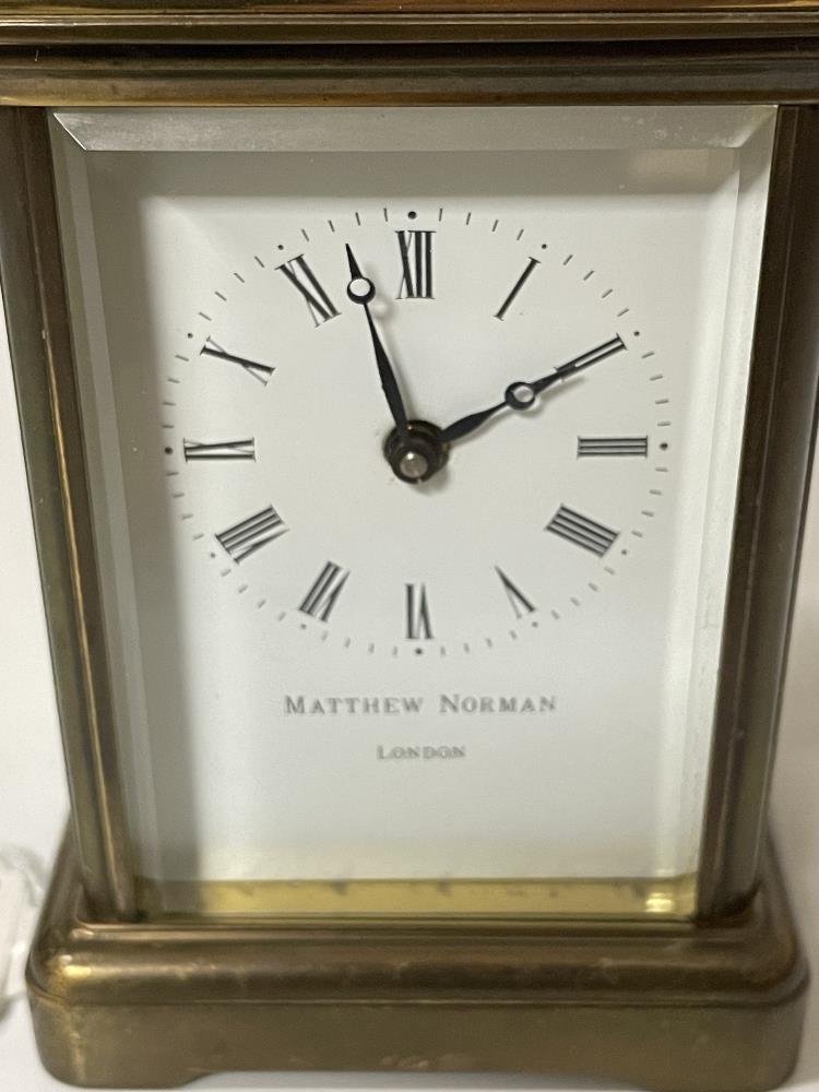 A BRASS CARRIAGE CLOCK WITH WHITE ENAMEL DIAL- MICHAEL NORMAN , LONDON, IN WORKING ORDER WITH KEY. - Image 2 of 8