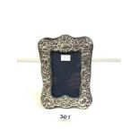 A HALLMARKED SILVER, EMBOSSED PHOTO FRAME, LONDON 1984. 13X8.