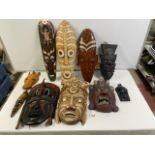 NINE CARVED WOODEN AFRICAN TRIBAL MASKS.