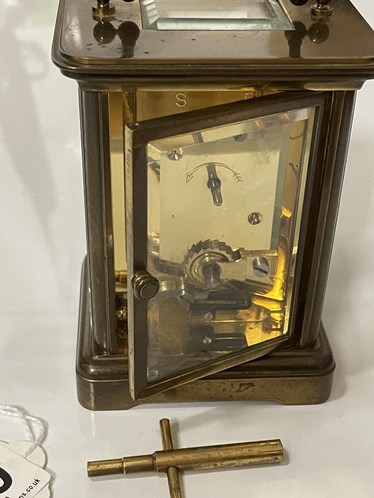 A BRASS CARRIAGE CLOCK WITH WHITE ENAMEL DIAL- MICHAEL NORMAN , LONDON, IN WORKING ORDER WITH KEY. - Image 8 of 8