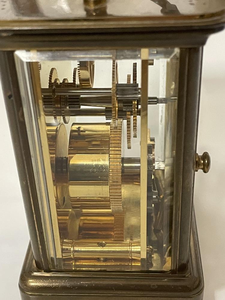 A BRASS CARRIAGE CLOCK WITH WHITE ENAMEL DIAL- MICHAEL NORMAN , LONDON, IN WORKING ORDER WITH KEY. - Image 6 of 8