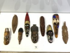 EIGHT SMALL CARVED WOODEN TRIBAL MASKS, SOME PAINTED.