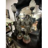 A PAIR OF VICTORIAN SPELTER CAVALIER FIGURE TABLE LAMPS WITH FLAME GLASS SHADES, 70 CMS.