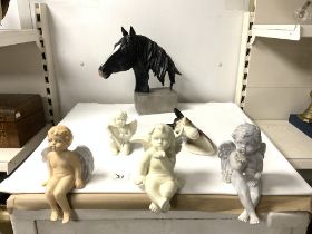 FOUR CHERUB SEATED FIGURES, AND TWO BUSTS OF HORSES.