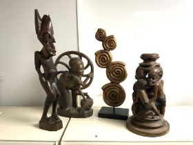 FOUR CARVED AFRICAN WOODEN TRIBAL FIGURES. 53CMS TALLEST.