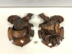 A PAIR OF CARVED BLACK FOREST WOLF AND DOG WALL PLAQUES; 30 X 23 CMS.