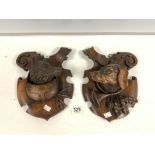 A PAIR OF CARVED BLACK FOREST WOLF AND DOG WALL PLAQUES; 30 X 23 CMS.