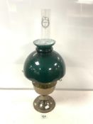 A VINTAGE ALADDIN BRASS OIL LAMP WITH GREEN GLASS SHADE.