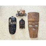 THREE AFRICAN TRIBAL WALL MASKS AND A SOUTH AMERICAN WALL MASK