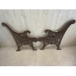 A PAIR OF ORNATE CAST IRON GARDEN BENCH ENDS.