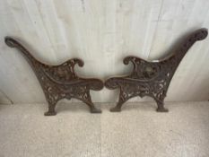 A PAIR OF ORNATE CAST IRON GARDEN BENCH ENDS.