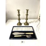 A PAIR OF VICTORIAN BRASS CANDLESTICKS 27CMS, AND PAIR OF FISH SERVERS IN CASE.