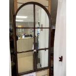 AN ARCHED WOODEN MIRROR, 57 X 109CMS