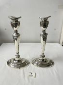 A PAIR OF ANTIQUE OVAL WHITE METAL CANDLESTICKS, 30CMS.