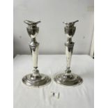 A PAIR OF ANTIQUE OVAL WHITE METAL CANDLESTICKS, 30CMS.