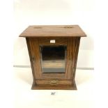 A SMOKERS GLAZED OAK CABINET WITH FITTED INTERIOR 32 X 39 CMS.