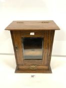 A SMOKERS GLAZED OAK CABINET WITH FITTED INTERIOR 32 X 39 CMS.