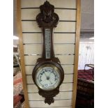 VICTORIAN CARVED MAHOGANY ANEROID BAROMETER AND THERMOMETER WITH WHITE ENAMEL DIALS