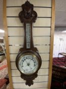 VICTORIAN CARVED MAHOGANY ANEROID BAROMETER AND THERMOMETER WITH WHITE ENAMEL DIALS