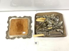 A SILVER PLATED BREAD BOARD AND A QUANTITY OF PLATED CUTLERY.