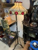 A VICTORIAN TELESCOPIC IRON LAMP STAND WITH A TIFFANY STYLE SHADE.