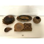 CARVED WOODEN TRIBAL DISHES AND VESSELS AND A RELIEF PANEL.