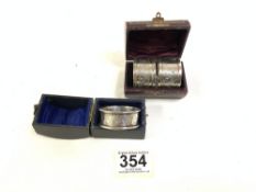 A PAIR OF VICTORIAN HALLMARKED SILVER NAPKIN RINGS IN CASE; BIRMINGHAM AND ONE OTHER IN CASE