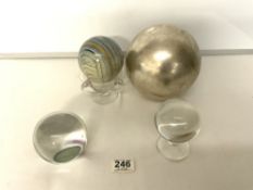 A CRYSTAL BALL ON STAND, CLEAR GLASS PAPERWEIGHT, A COLOURED WOODEN BALL ON THREE HANDLE GLASS BOWL,