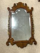 VINTAGE BEVELLED EDGED WALL MIRROR IN A MAHOGANY FRAME WITH GILDED FLOWER DECORATION 100 X 57 CM