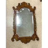 VINTAGE BEVELLED EDGED WALL MIRROR IN A MAHOGANY FRAME WITH GILDED FLOWER DECORATION 100 X 57 CM