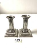 A PAIR OF HALLMARKED SILVER CORINTHIUM COLUMN CANDLESTICKS ON STEPPED SQUARE BASES, 12 CMS,