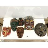 SIX CARVED AND DECORATED INDONESIAN MASKS.