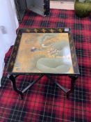 A CHINESE BLACK AND GOLD LACQUERED DUCK DECORATED DRINKS TRAY ON FOLDING STAND, 54 X 60.