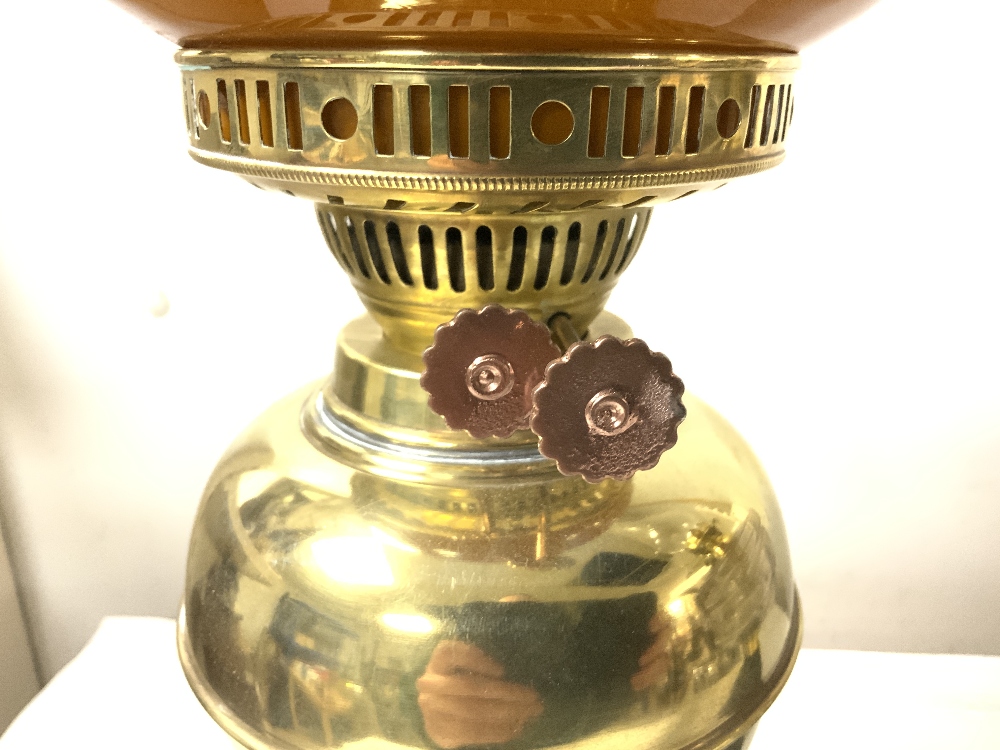 A VICTORIAN IRON-BASED OIL LAMP WITH A GLASS FRONT, AND A LATER BRASS OIL LAMP WITH SHADE. - Image 2 of 4