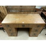 A 1930s OAK KNEEHOLE DRESSING TABLE, WITH HAMMERED METAL HANDLES. 106 X 52X 70.