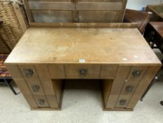 A 1930s OAK KNEEHOLE DRESSING TABLE, WITH HAMMERED METAL HANDLES. 106 X 52X 70.