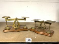 TWO SETS OF VICTORIAN BRASS POSTAL SCALES WITH SOME WEIGHTS.